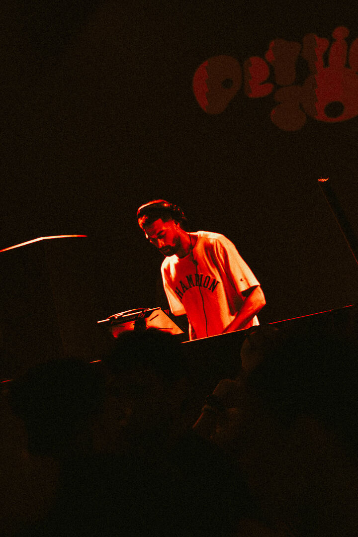 DJ behind the decks in red light